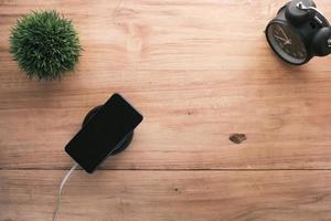 charging Smartphone using Wireless Charging Pad, top view photo