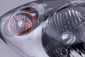 closeup of a car headlight on bright background. trimmed car headlight photo