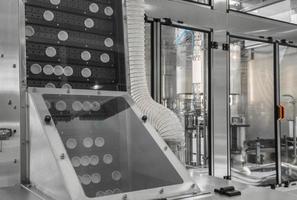 conveyor with lids for bottles at the milk factory. equipment at the dairy plant photo