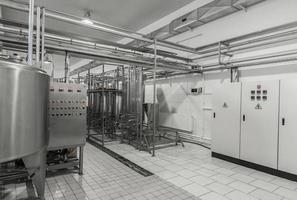 general view of the interior of a milk factory. equipment at the dairy plant photo
