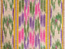 Background from the tissue with oriental ornaments and multi colored pattern, textile photo