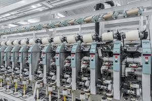 Machinery and equipment in the workshop for the production of thread. Industrial textile factory photo