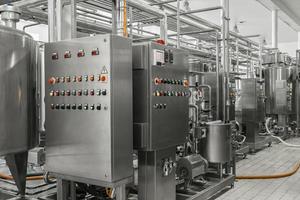 electronic control panel and tank at a milk factory. equipment at the dairy plant photo