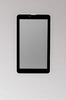 Black a tablet with reflection on a dark background closeup photo