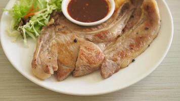 grilled pork chop steak with Thai spicy dipping sauce or Jaew sauce - fusion food style
