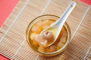 Chinese desserts, Mix ginkgo nuts cassava syrup coconut jelly in longan juice on glass bowl, Thai and Chinese longan date soup Asian dessert sweets photo