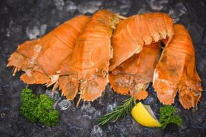 Flathead lobster shrimps on ice, fresh slipper lobster flathead boiled for cooking with lemon parsley rosemary in the seafood restaurant kitchen or seafood market, Rock Lobster Moreton Bay Bug photo