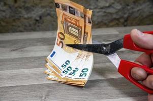 cut 50 banknotes with euro scissors photo