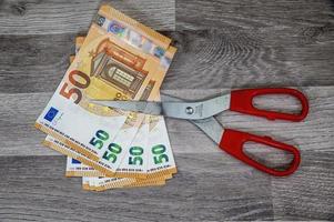 cut 50 banknotes with euro scissors photo