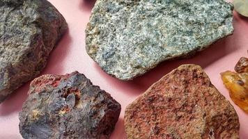 Closeup rock samples consisted of schistmica, scaly clay, marl, chert, iron ore, altered andesite, and jasper. Geological collection for study about minerals, Indonesia. photo