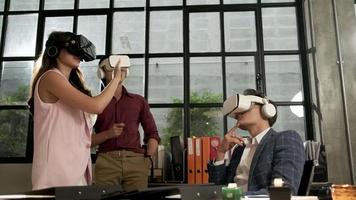 Multiracial workers use VR headset simulator equipment to visualization 3D cyberspace, view and interactive touch, futuristic digital workspace at the office, gadget device, exciting experience. video