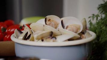 Bowl with fresh mussels, process of mediterranean dish preparation at home.