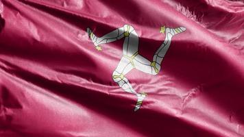 Isle of man textiel vlag langzaam zwaaien op de wind-lus. isle of man banner soepel zwaaiend op de wind. stof textiel weefsel. volledige vulling achtergrond. 20 seconden lus. video