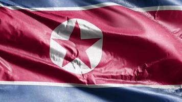 bandeira têxtil da coreia do norte acenando no loop de vento. bandeira norte-coreana balançando na brisa. tecido tecido têxtil. fundo de preenchimento completo. loop de 10 segundos. video