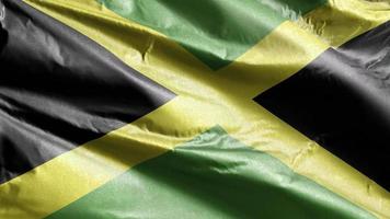 jamaica textil flagga långsamt viftande på vindslingan. jamaicansk banderoll svajar smidigt på vinden. tyg textilvävnad. full fyllning bakgrund. 20 sekunders loop. video