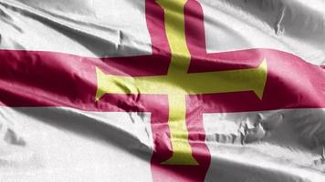 Guernsey textile flag waving on the wind loop. Gernian banner swaying on the breeze. Fabric textile tissue. Full filling background. 10 seconds loop. video