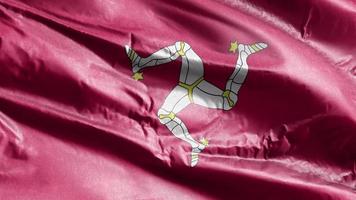 Isle of Man textile flag waving on the wind loop. Isle of Man banner swaying on the breeze. Fabric textile tissue. Full filling background. 10 seconds loop. video