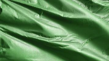 Libya textile flag from 1977 to 2011 slow waving on the wind loop. Libyan banner smoothly swaying on the breeze. Fabric textile tissue. Full filling background. 20 seconds loop. video