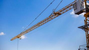 Construction cranes in blue sky at construction site. photo
