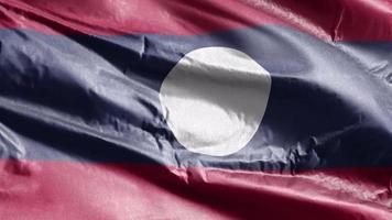 bandeira têxtil do laos acenando no loop de vento. bandeira do Laos balançando na brisa. tecido tecido têxtil. fundo de preenchimento completo. loop de 10 segundos. video