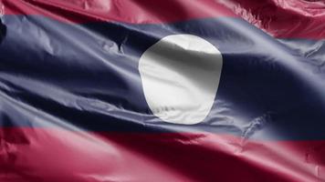 Laos flag slow waving on the wind loop. Laotian banner smoothly swaying on the breeze. Full filling background. 20 seconds loop. video