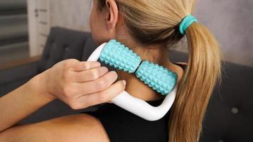 Woman massaging herself with body roller. Neck massage. Prevention of neck pain photo