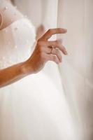 Wedding morning. Close up of bride preparing for the wedding day. Luxury bridal dress close up. Best bridal morning. Bride during the first meeting with the groom at wedding day. photo