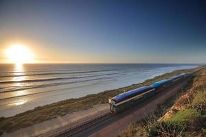 Amtrak trains along the San Diego coastline at dusk photo