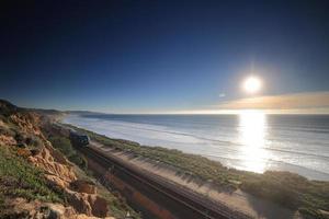 Amtrak trains along the San Diego coastline at dusk photo