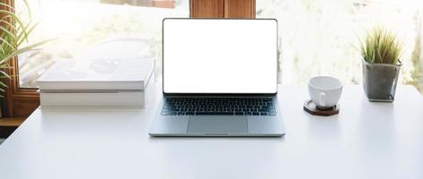 Digital tablet with white blank screen on table. workspace in modern office concept. photo