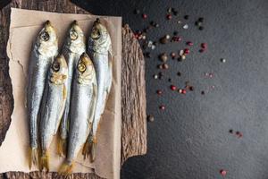 smoked sprat fish herring salted seafood meal food snack on the table photo