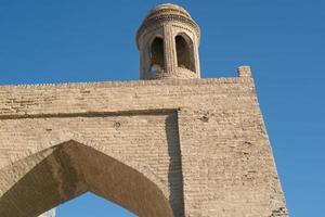 Old building with arch and dome. The ancient buildings of medieval Asia. Bukhara, Uzbekistan photo