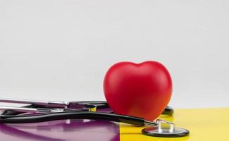 Toy heart and stethoscope on a colored background. Concept healthcare. Cardiology - care of the heart photo