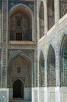 Arch and architecture of the ancient Registan in Samarkand. Ancient architecture of Central Asia photo
