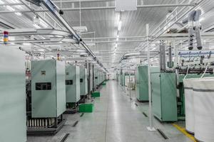 Machinery and equipment in the workshop for the production of thread. Interior of industrial textile factory photo