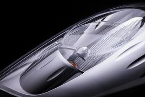 closeup of a car headlight on a black background. trimmed car headlight photo