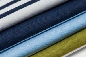 background of colorful fabrics and textiles stacked on one another photo
