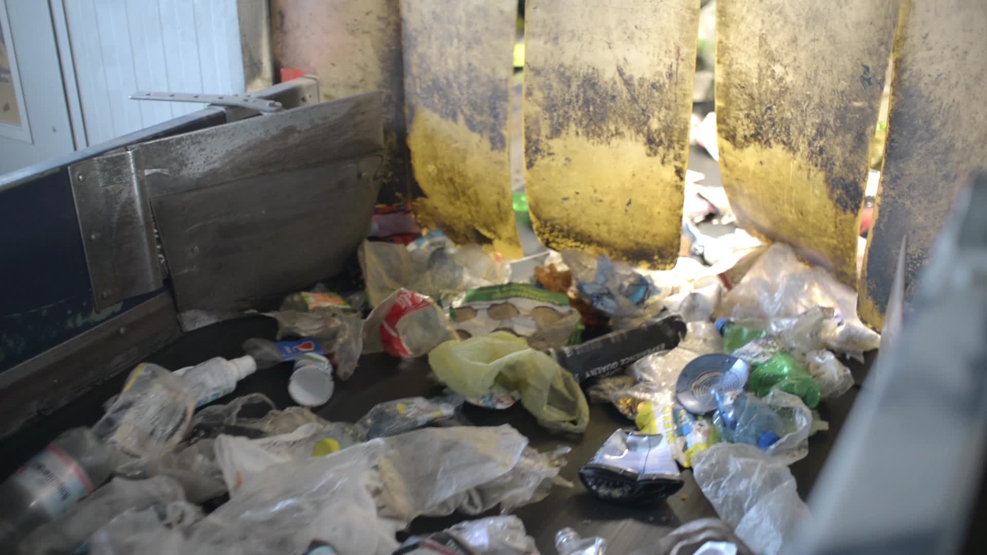 Plastic Trash waste moving on a Conveyor at the Garbage sorting Station