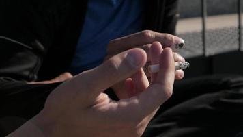 Close-up of Hands with smoking Cigarettes outdoors video