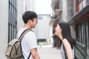 Traveler Asian backpacker couple feeling happy traveling in Beijing, China, cheerful young teenager couple walking at Chinatown. Lifestyle backpack tourist travel holiday in city concept. photo