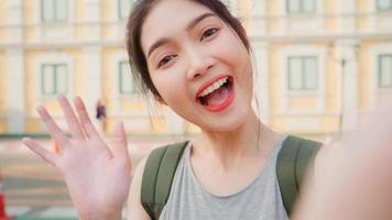 Asian blogger woman travel in Bangkok, Thailand, backpacker female using mobile phone make vlog and live in social media while spending sweet time in holiday trip. Women travel in city concept. photo