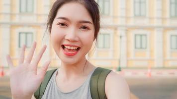 Asian blogger woman travel in Bangkok, Thailand, backpacker female using mobile phone make vlog and live in social media while spending sweet time in holiday trip. Women travel in city concept. photo