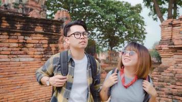 Traveler Asian couple spending holiday trip at Ayutthaya, Thailand, backpacker sweet couple enjoy their journey at amazing landmark in traditional city. Lifestyle couple travel holidays concept. photo