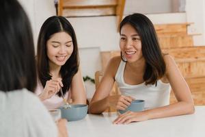 Asian women have breakfast at home, Group of young Asia friend girls feeling happy fun talking together while have breakfast in kitchen in the morning concept. photo