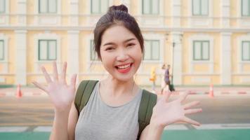 Asian blogger woman travel in Bangkok, Thailand, backpacker female using mobile phone make vlog and live in social media while spending sweet time in holiday trip. Women travel in city concept. photo