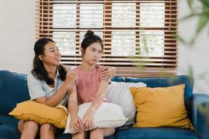 Young Lesbian lgbtq Asian women couple angry conflict together at home. Asia female sad flight annoyed on sofa in living room, teenager young girl upset, break up, unhappy concept. photo