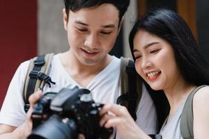 Traveler Asian couple using camera for take a picture while spending holiday trip at Beijing, China, couple enjoy journey at amazing landmark in city. Lifestyle couple travel in city concept. photo