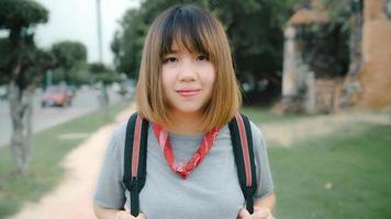 Traveler Asian woman feeling happy smiling to camera holiday trip at Ayutthaya, Thailand, backpacker female enjoy his journey at amazing landmark in traditional city. Lifestyle travel holidays concept photo