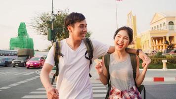 Traveler Asian couple traveling and walking in Bangkok, Thailand, sweet Asia couple feeling happy spending sweet time in holiday trip in sunset. Lifestyle couple travel in city concept. photo