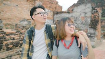 Traveler Asian couple spending holiday trip at Ayutthaya, Thailand, backpacker sweet couple enjoy their journey at amazing landmark in traditional city. Lifestyle couple travel holidays concept. photo